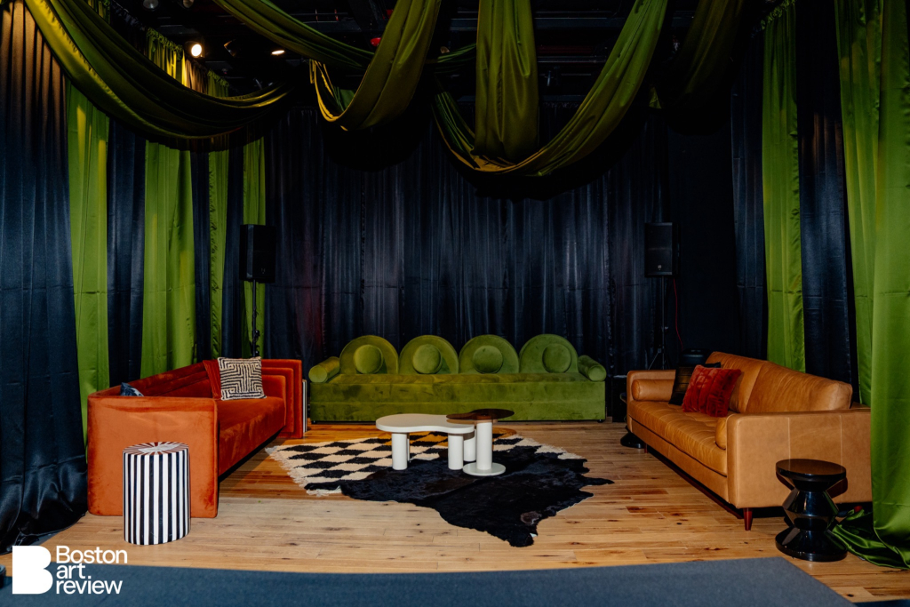 Kadeema Rentals lounge vignette at the Boston Art Review Issue 14 launch party featuring the Carrie Daybed, Houston Leather Sofas, Cloud and Glass Nesting Table, BW Stripe Table, Diamond Shag Rug layered with a Black Cowhide Rug, Black Zig Zag Side Table, assorted pillows, and Simplistic Charm's dramatic luxury drapery.