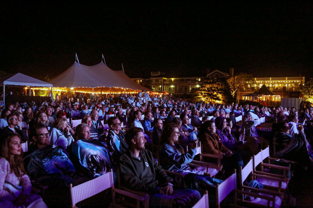 Evening atmosphere at the JAWS 50th anniversary screening with furnished VIP seating and outdoor lighting.
