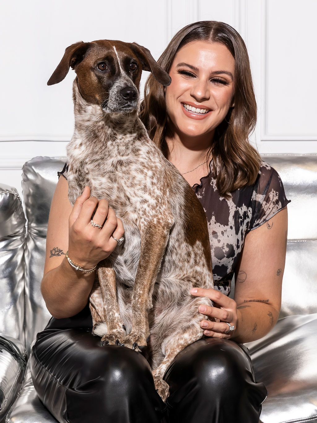Kelsey, Design Consultant at Kadeema Rentals, seated with Bella, the Kadeema office support dog, in a styled studio setting.