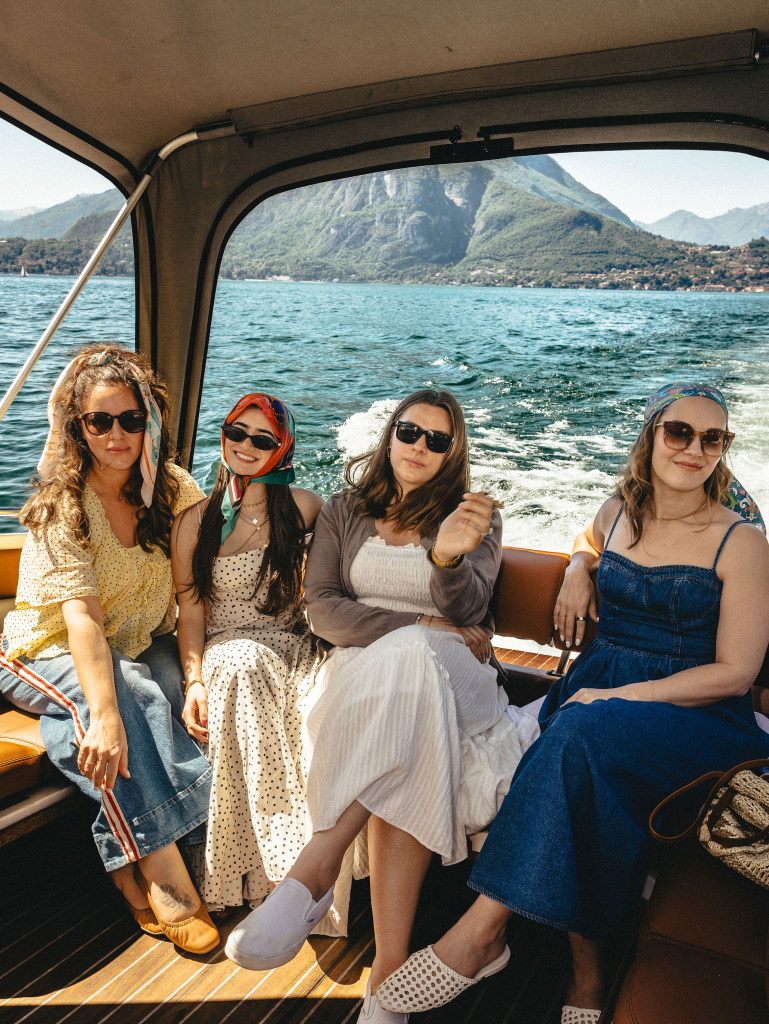 Four women riding on a boat on Lake Como, Italy
